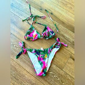 Woman's pink parrot bikini.